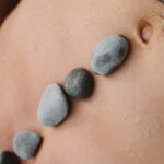 black stones on human skin